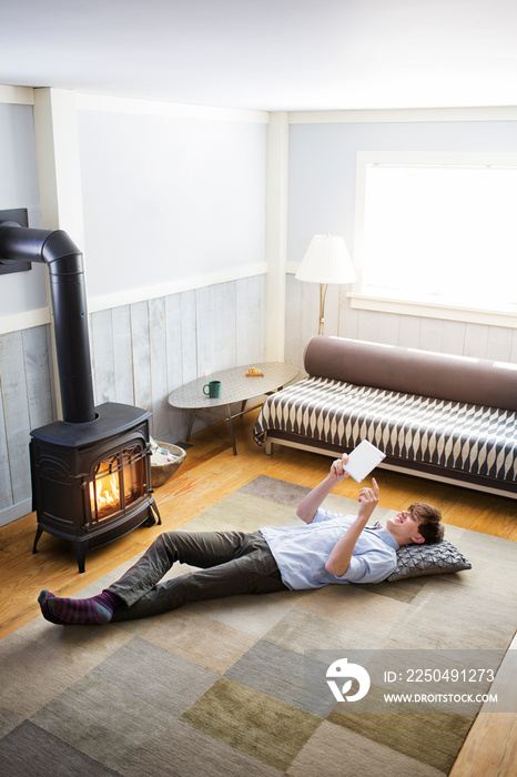 Young man using tablet pc in living room