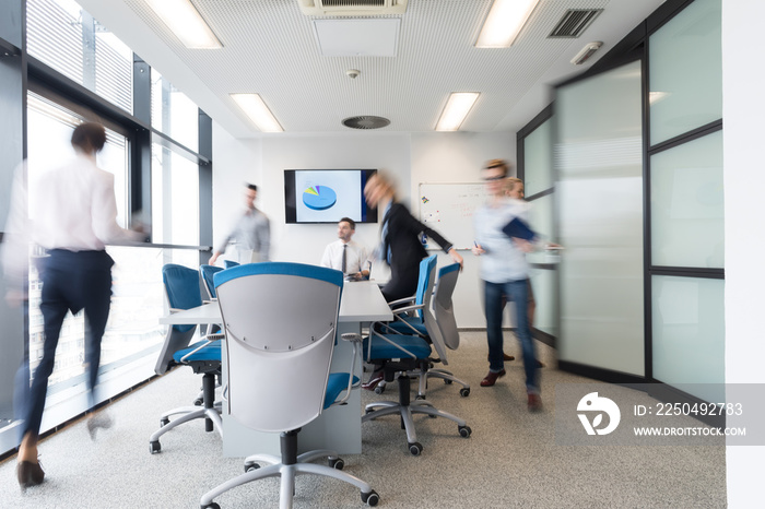 business people group entering meeting room, motion blur