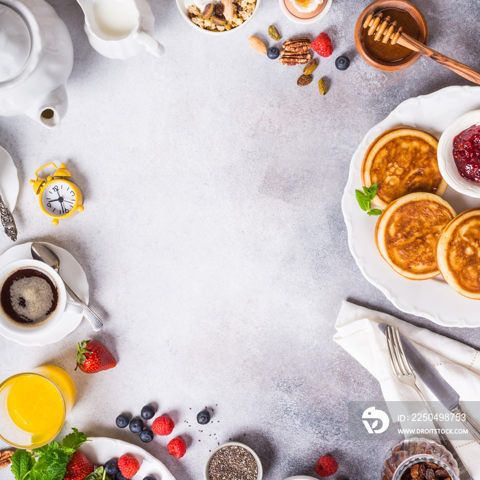 Healthy breakfast background with coffee, pancakes, fresh berries, quick cereals and orange juice, c