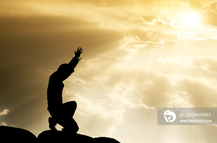 praying man on beautiful sky background