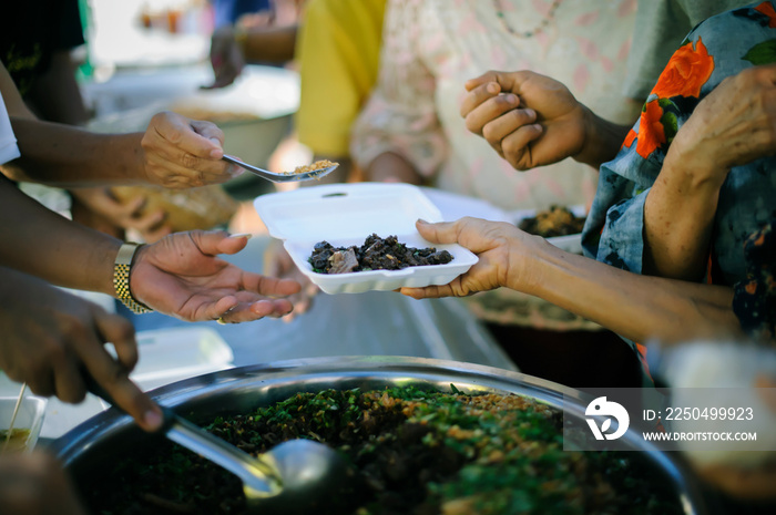 Homeless people are helped with food relief, famine relief : volunteers giving food to poor people i