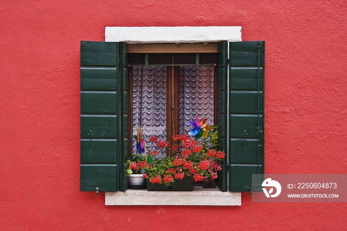 Open Shuttered Window in Red Wall