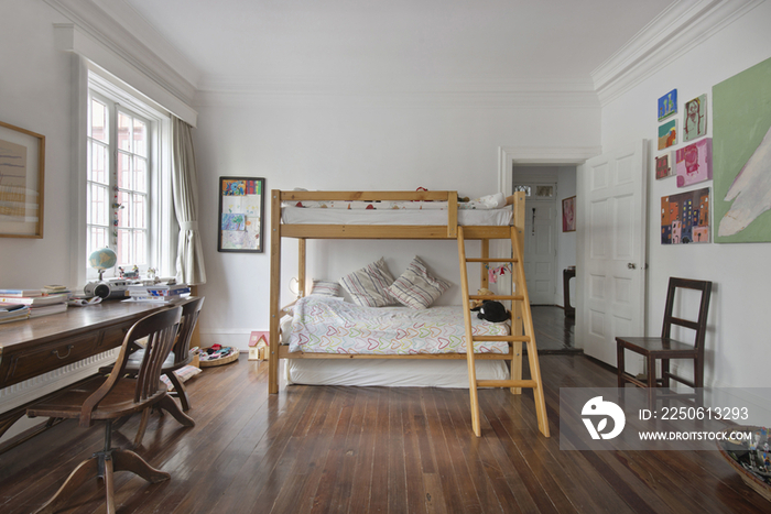 Spacious kids room with bunk bed and study desk at home