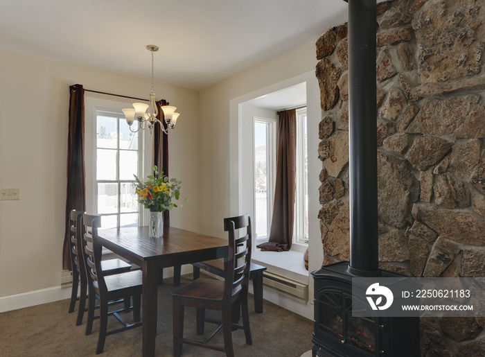 Dining table by chimney in house