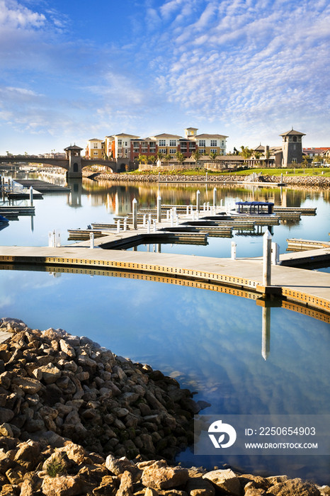 Piers and residential buildings against cloudy sky; Oxnard; California; USA