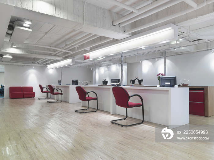 Row of desks and chairs in office