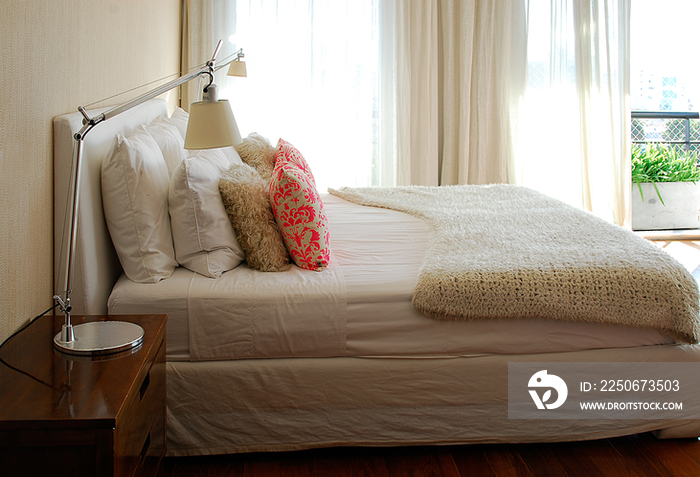 Bed and night table in bedroom; Argentina