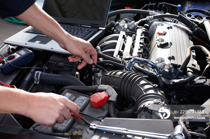 Car mechanic working in auto repair service.