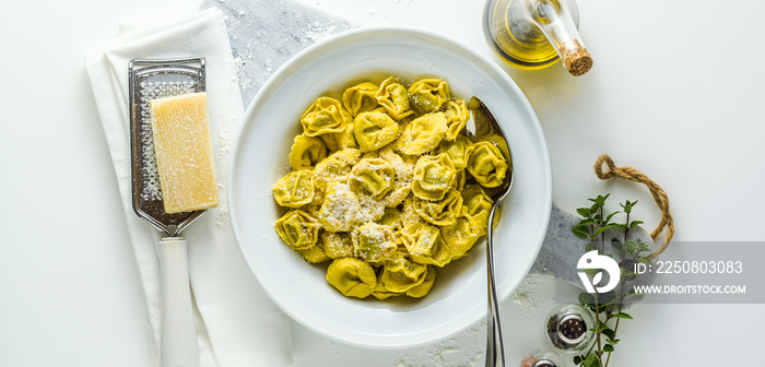 banner of plate of italian cooked ravioli tortellini with parmesan cheese on the table. healthy Medi