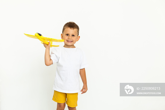 happy child toddler playing with yellow toy airplane