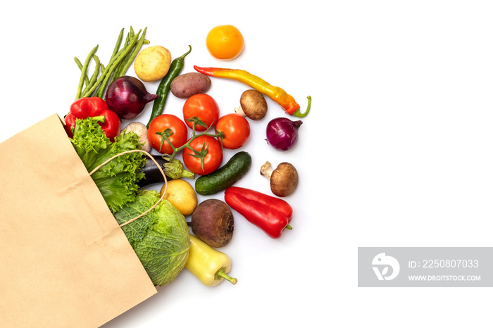 Fresh vegetables in eco friendly paper bag on white background, top view. Food delivery. Grocery sho