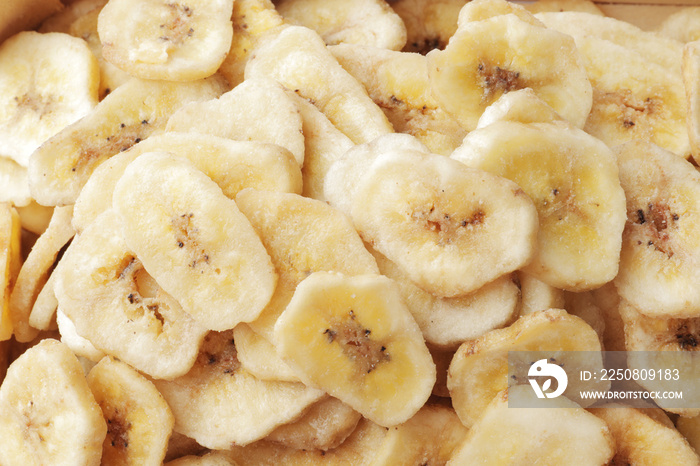 Heap of sweet banana slices on white background. Dried fruit as healthy snack