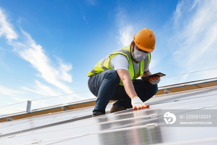 Male Engineer Inspects Solar Panels on Hospital Building Roofs, Solar Panel Maintenance Inspector