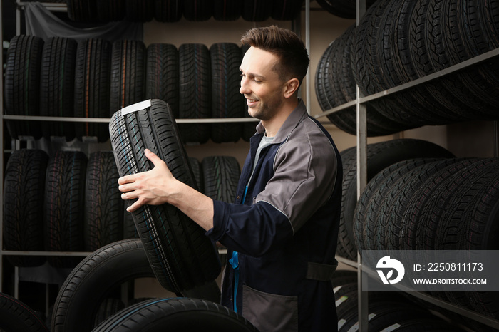 Male seller in car tire store