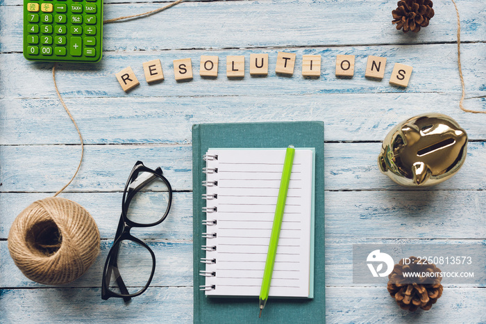 RESOLUTIONS word and a notepad on a light background