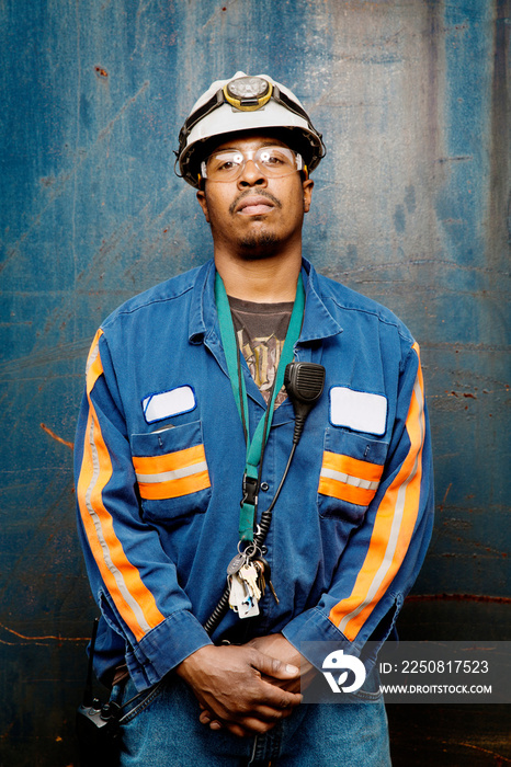 Portrait of industrial worker in front of wall