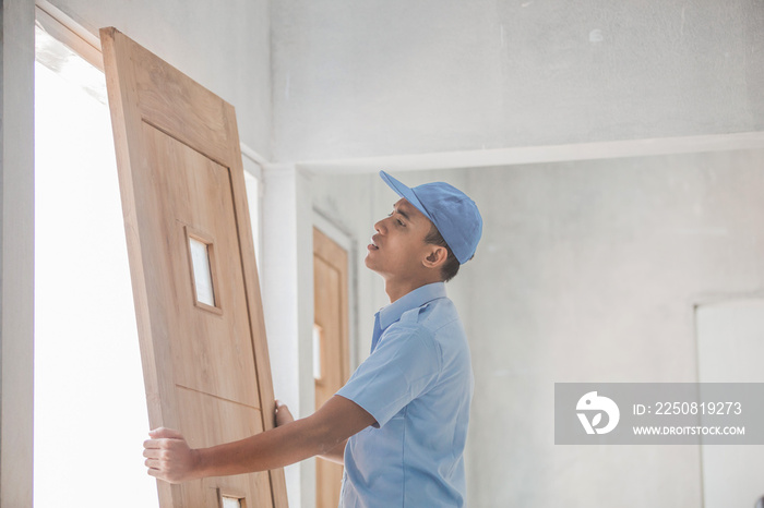 Worker installing doors