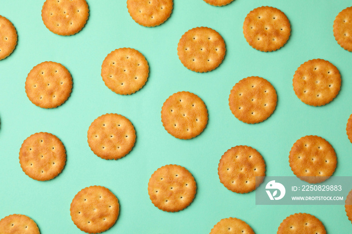 Flat lay with cracker biscuits on mint background