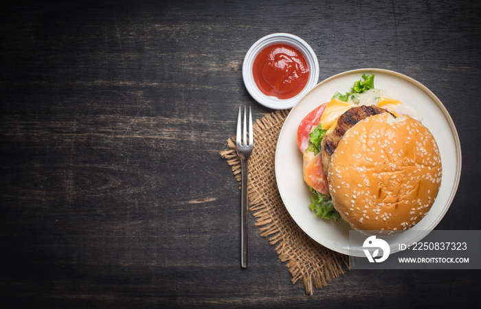 Fresh homemade burger cheeseburger on dark wooden background,