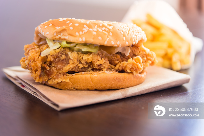 hamburger with fried chicken on wood background. Fast food or junk food in an urgent time.