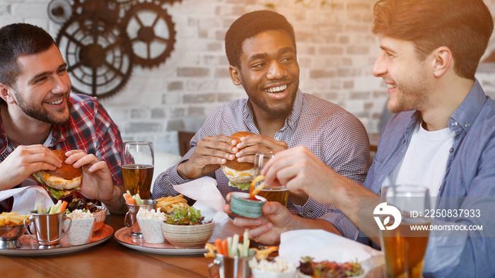 Men Enjoying Burgers And Beer, Resting In Bar