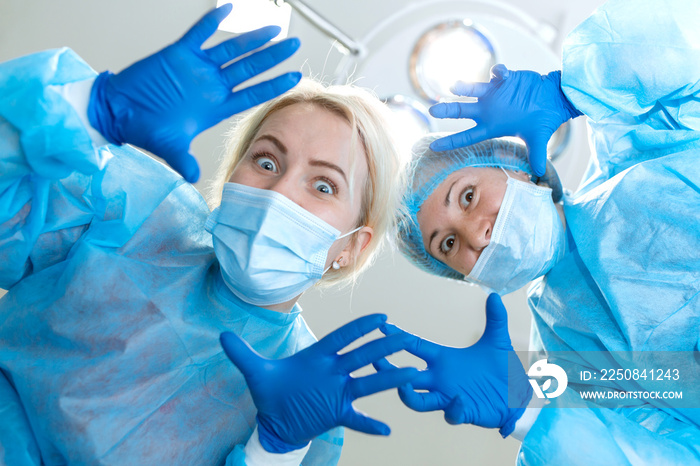 Crazy scary and funny doctors surgeons dentists in masks with gloves and coats scare and tease on ca