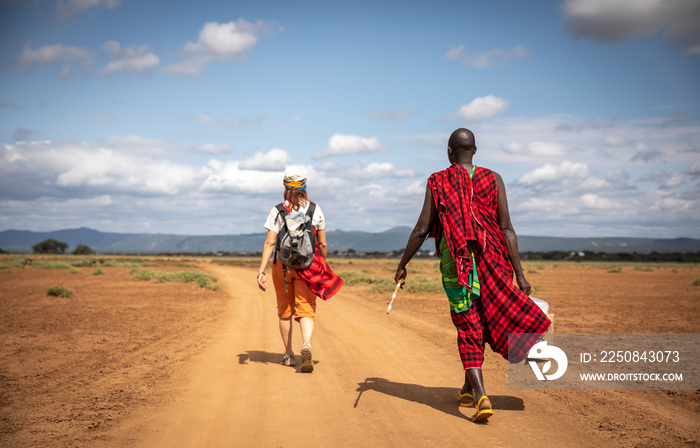 hikers walking on a dusty road