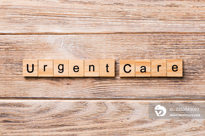 Urgent care word written on wood block. Urgent care text on wooden table for your desing, concept