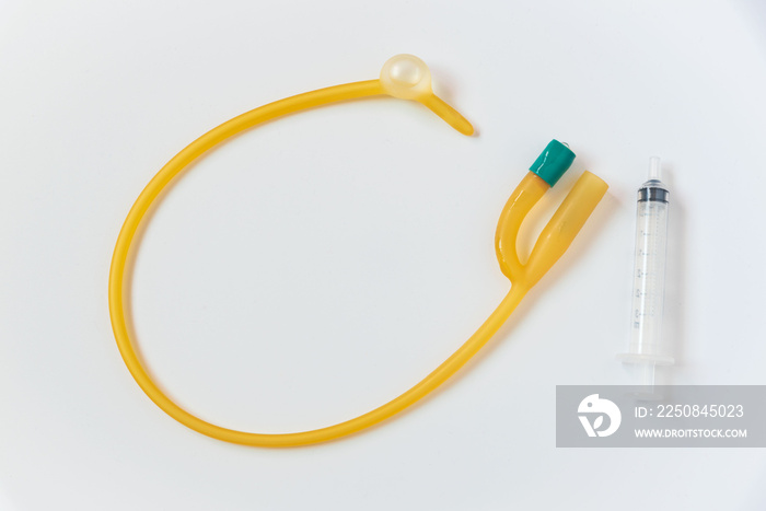 Foley catheter and syringe on white background