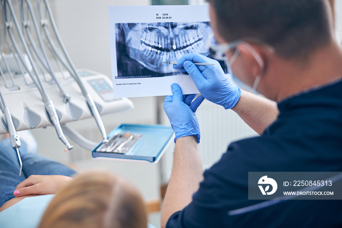 Surgeon with female discussing her jaw x-ray