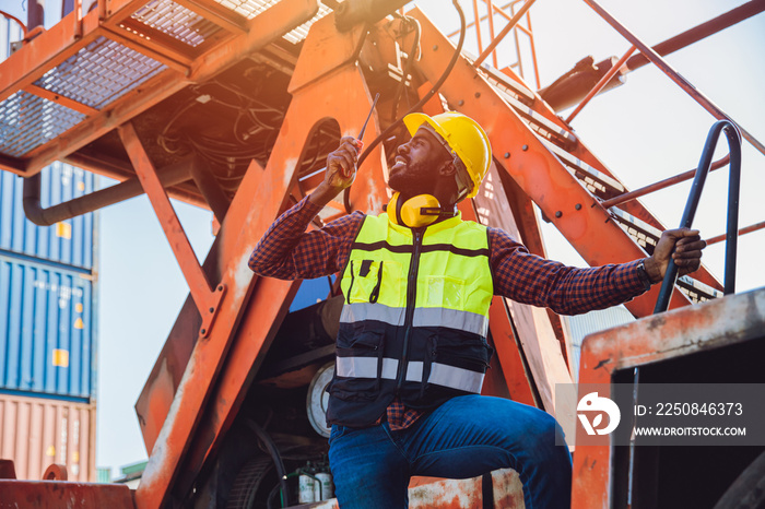 Black African male worker work as port cargo manager using radio control loading container in logist