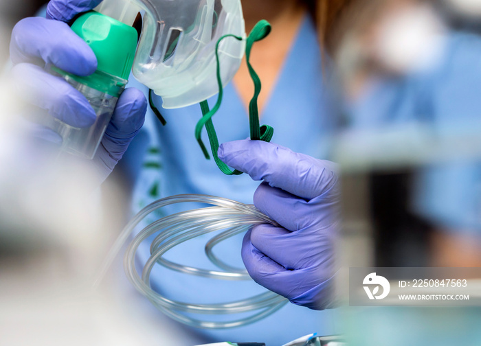 Nurse prepares oxygen mask in hospital, conceptual image