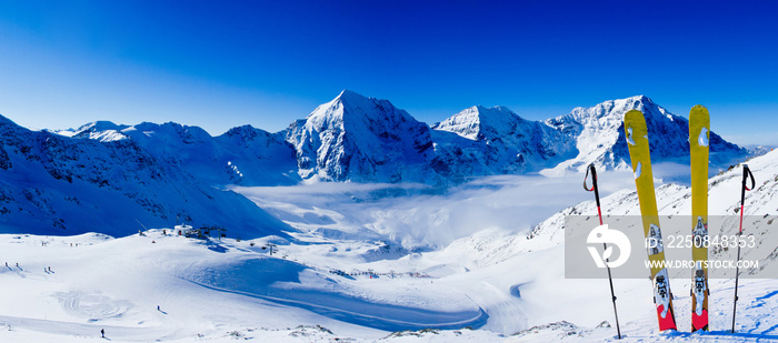 Ski in winter season, mountains and ski touring backcountry equipments on the top of snowy mountains