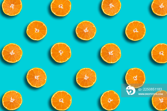 Colorful fruit pattern of Dekopon fresh orange slices on blue background, spring, summer cocept.