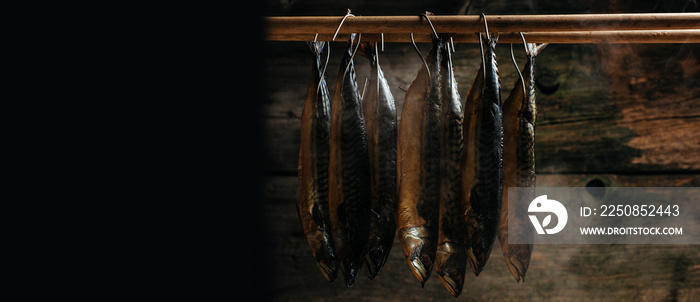 Mackerel Fish smoked in smokehouse. Smoking Process Fish. Smoking fish hanging side by side in a smo