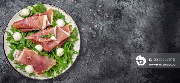 Antipasto salad with prosciutto, mozzarella cheese and arugula, Antipasti, a traditional Italian, Fo