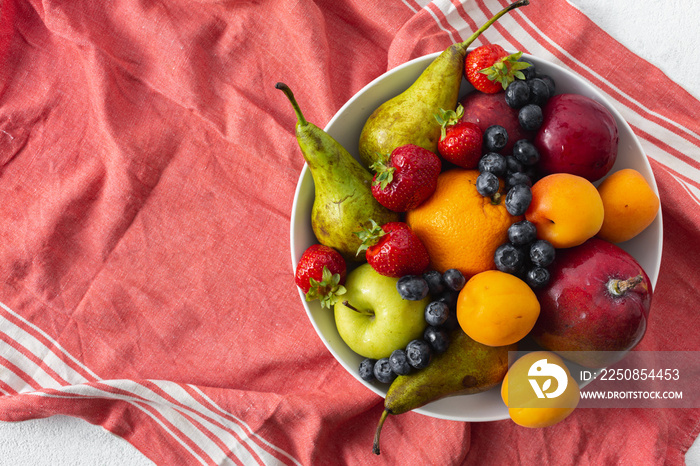 Mix fruits plate on a light background top view