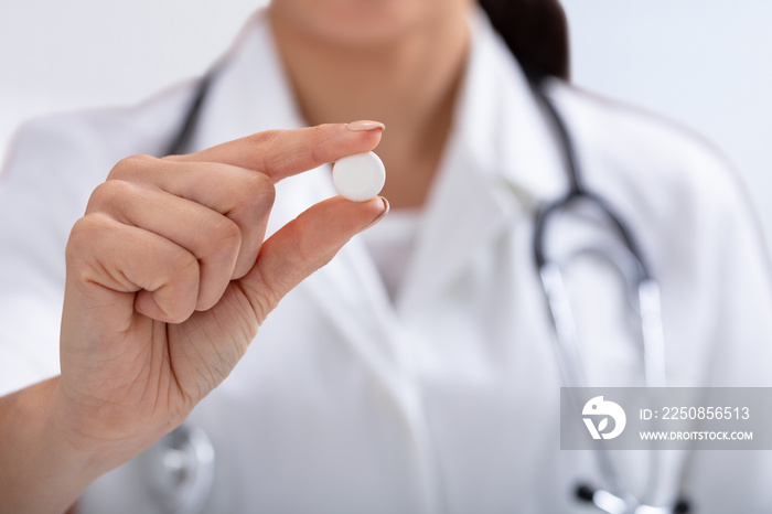 Female Doctor Holding White Tablet In Hand