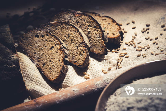 dark sliced ​​bread with wheat and flour on the table. Sliced ​​rye bread on a close-up on the table