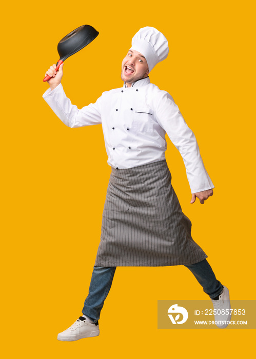 Funny Chef Jumping Posing With Frying Pan Over Yellow Background