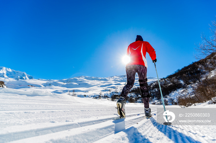 Woman cross country skie on a sunny winter morning in French Alps, 3 Valleys.