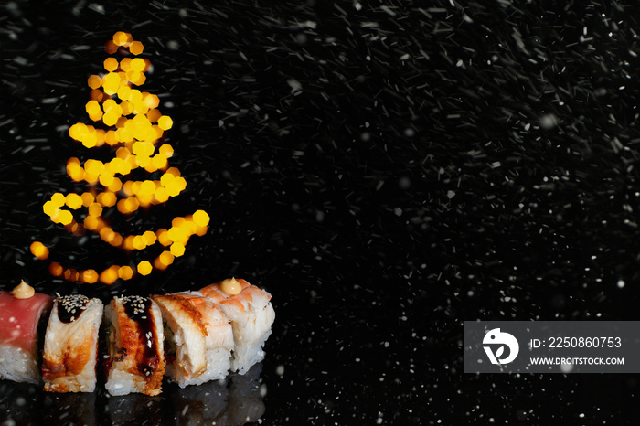 Sushi rolls New Year. Christmas background. Idea for postcard, menu, advertising. Roll on dark backg