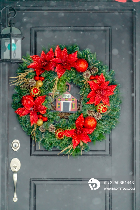 Dark front door with red and gold Christmas wreath