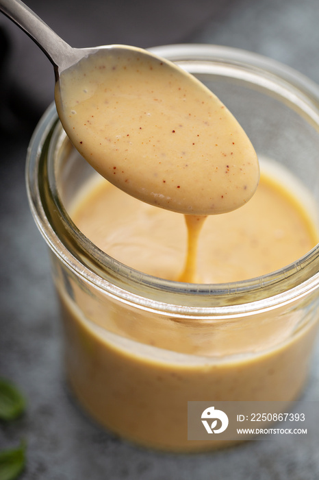 Homemade honey mustard sauce in a glass jar