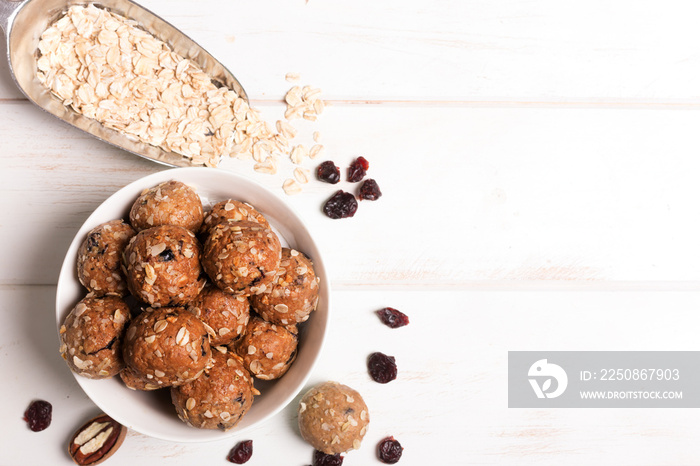 Healthy organic energy granola bolls with nuts, cacao, oats and raisins - vegetarian sweet bites wit