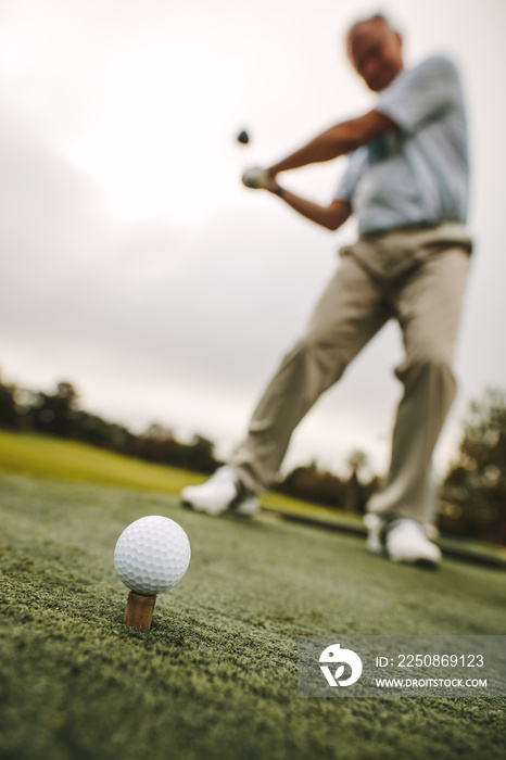 Practicing swing at golf course driving range