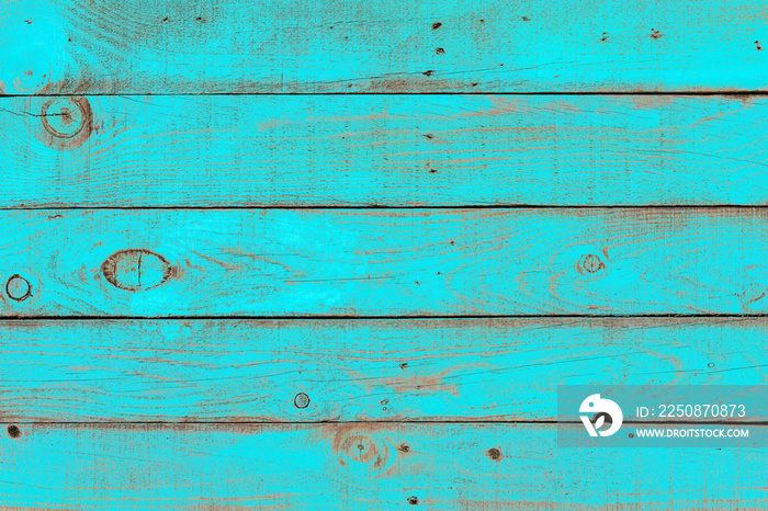 Old weathered wooden plank painted in turquoise blue color. Vintage beach wood background.