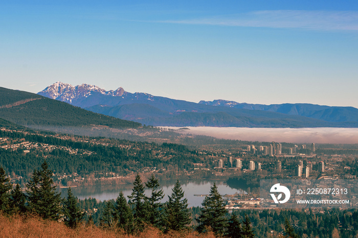 Dense winter cloud inversion rolling across Fraser Valley, BC, to Coquitlam Town Center and Port Moo