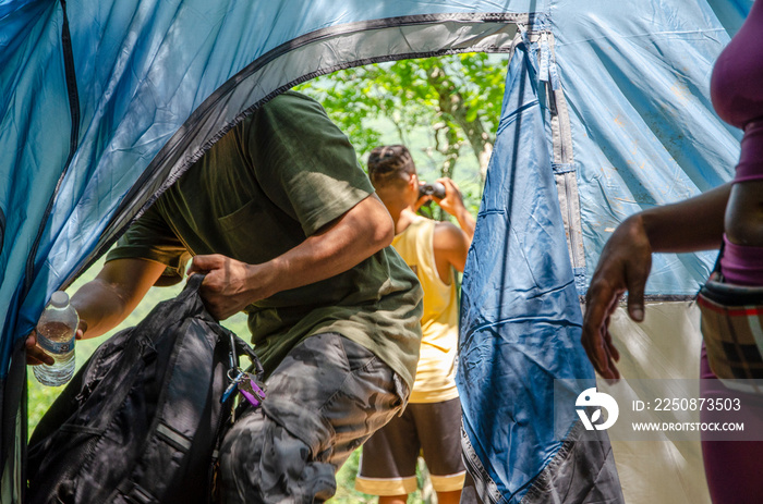 Young man entering tent