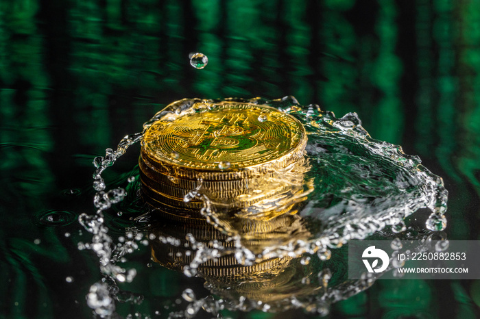 Gold bitcoin coin falling to water. Bitcoin and water splash.